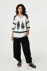 Ikat Print Tassel Tie Neck Blouse