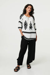 Ikat Print Tassel Tie Neck Blouse